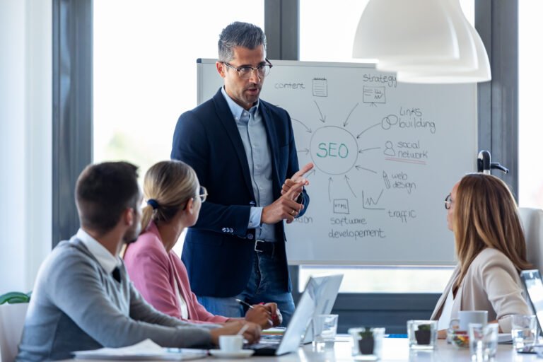 Handsome businessman explaining a project to his colleagues on c